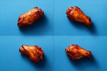 four Buffalo wings on Blue Background - Feels like an image inserted in a magazine