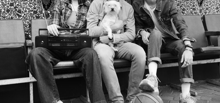 Friends enjoying a sunny day while holding a dog and a basketball - Powered by Adobe