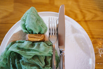Elegant table setting with green napkin and cutlery