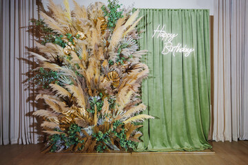Beautiful birthday backdrop with greenery and decorations