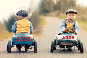 the new year 2026 is coming, cute little boy ride his car in the new year and out of the old year