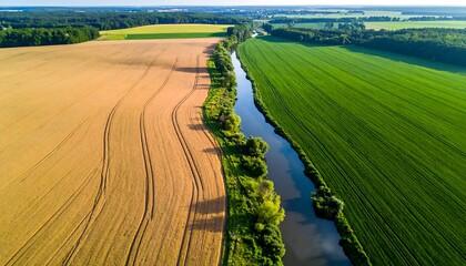 Aerial view of fields separated by a river, with varied colors