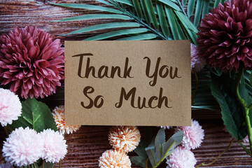 Thank You so much text with flowers bouquet decoration on wooen background