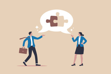 Business collaboration concept with two colleagues solving a puzzle.