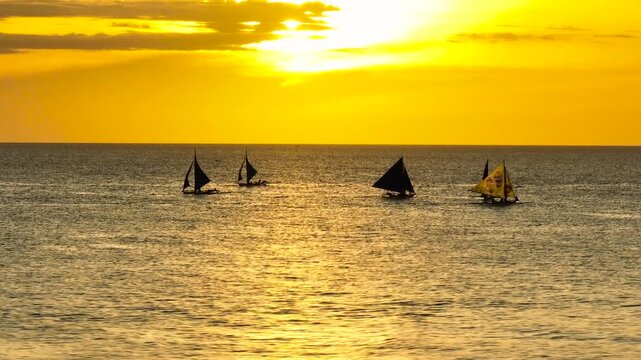 Beautiful scenery of Sunset over the sea and boats in Boracay, Philippines.