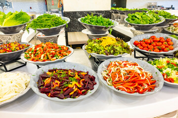 Mediterranean cuisine, olive oil, healthy and delicious  salad varieties with green vegetables.Vegetarian and vegan healty food, open buffet in a luxury hotel. Meze varieties, salad bar.