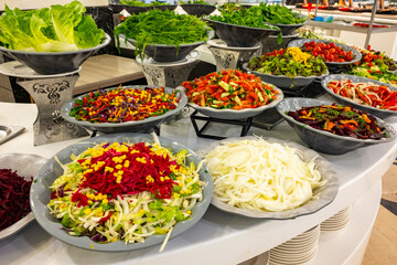 Mediterranean cuisine, olive oil, healthy and delicious  salad varieties with green vegetables.Vegetarian and vegan healty food, open buffet in a luxury hotel. Meze varieties, salad bar.