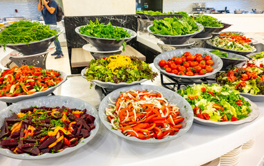 Mediterranean cuisine, olive oil, healthy and delicious  salad varieties with green vegetables.Vegetarian and vegan healty food, open buffet in a luxury hotel. Meze varieties, salad bar.