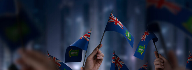British Virgin Islands flags in their hands on a blurred urban background