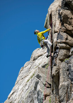 Climber ascending Anvil Chorus route at Bosigran Cornwall outdoors