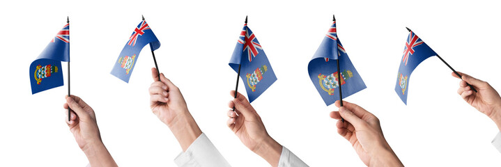 The Cayman Islands flag in hand in different angles on a white background