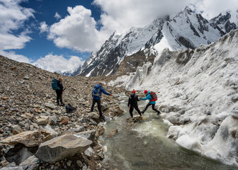 Small group trekking on snow and ice in the Karakorum mountains Pakistan