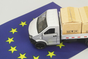 Lorry truck with many boxes and judge gavel on flag of European Union. EU tariffs and import...