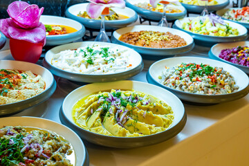 Mediterranean cuisine, olive oil, healthy and delicious  salad varieties with green vegetables.Vegetarian and vegan healty food, open buffet in a luxury hotel. Meze varieties, salad bar.