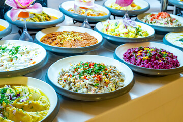 Mediterranean cuisine, olive oil, healthy and delicious  salad varieties with green vegetables.Vegetarian and vegan healty food, open buffet in a luxury hotel. Meze varieties, salad bar.