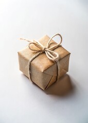 Small square brown gift box with twine tied neatly on a clean white surface