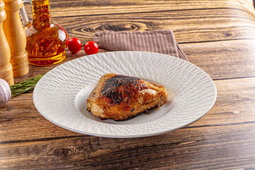 Roasted chicken thighs in the plate