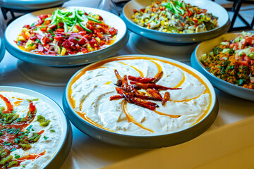 Mediterranean cuisine, olive oil, healthy and delicious  salad varieties with green vegetables.Vegetarian and vegan healty food, open buffet in a luxury hotel. Meze varieties, salad bar.