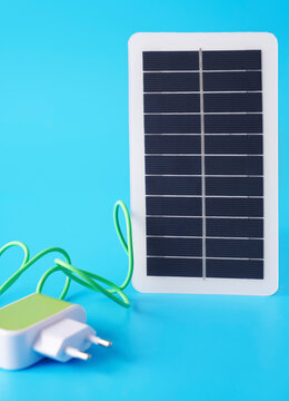 Solar panel and electric plug symbolizing renewable energy innovation
