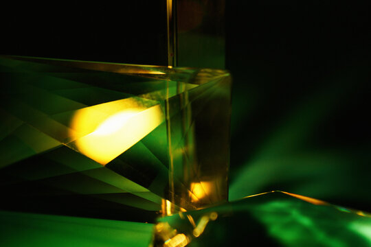 Abstract green glass prism with glowing neon light reflection