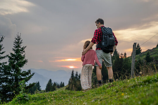 Father spending leisure time walking with daughter on mountain