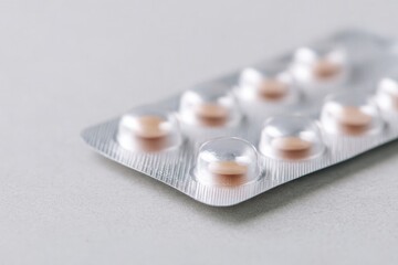 Shiny blister pack with soft-colored pills, highlighting modern