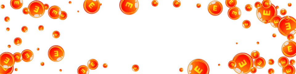 Vitamin E round capsules scattered randomly.