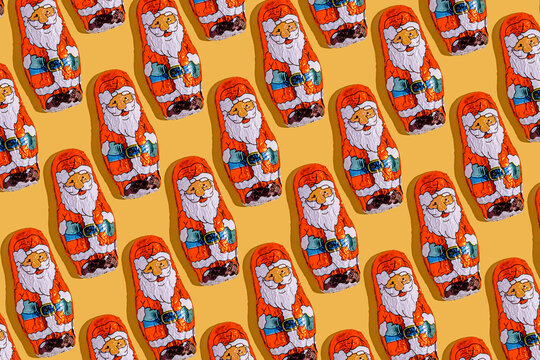 Santa Claus mini chocolate pattern on yellow background for Christmas