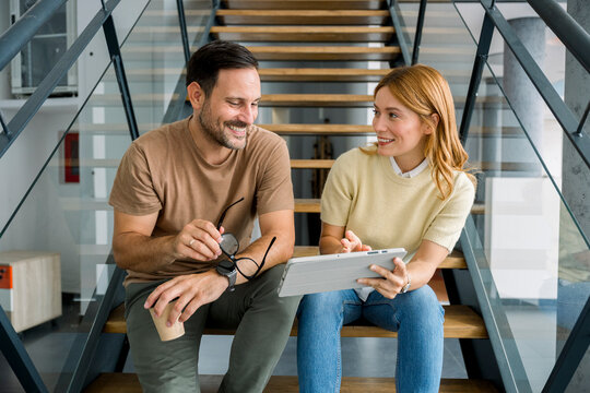 Business team collaborating on laptop in modern office setting