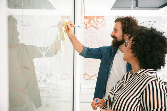 Optimistic colleagues brainstorming and planning in modern office