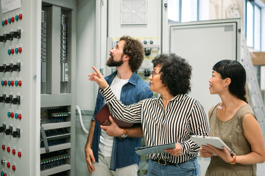 Business team consulting on renewable energy project in control room