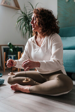Meditating indoors with Tibetan cymbals for sound healing and mindfulness