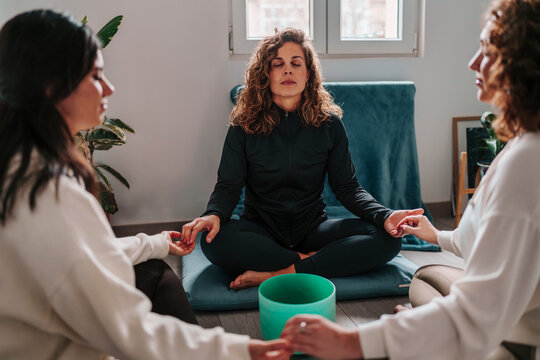 Group meditation session with sound healing and mindfulness practice indoors