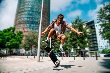 Skateboarder performing ollie trick in urban Barcelona city street