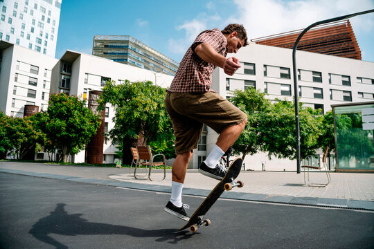 Skateboarder performing trick outdoors in urban Barcelona