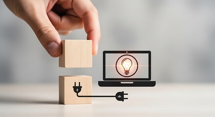 Hand placing a wooden block to complete a connection between a laptop with a lightbulb icon and a power plug, symbolizing innovation and ideas