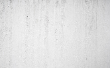 White wall with subtle texture, vertical water stains, and slight grunge effect, creating minimalist and neutral background suitable for design or copy space