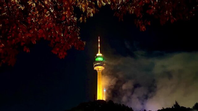 Thick Smoke Clouds From Fireworks Beside Tower at Night
