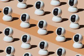 Multiple surveillance cameras arranged in playful pattern indoors