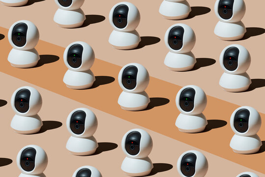 Multiple surveillance cameras arranged in playful pattern indoors