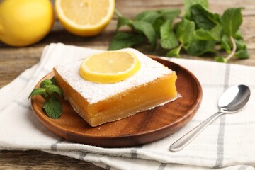 Tasty lemon bar with mint and fresh fruits on wooden table, closeup