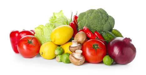 Pile of different fresh raw vegetables and lemons isolated on white