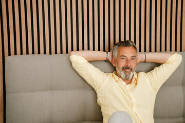 Mature adult relaxing at home smiling and planning financial future