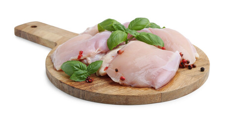 Raw chicken thighs with peppercorns and basil isolated on white
