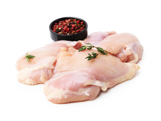Raw chicken thighs with peppercorns and thyme isolated on white