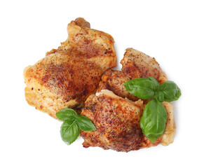 Tasty roasted chicken thighs with basil isolated on white, top view