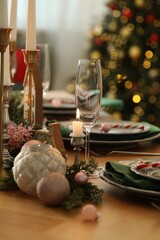 Festive table setting with Christmas decor at home, closeup