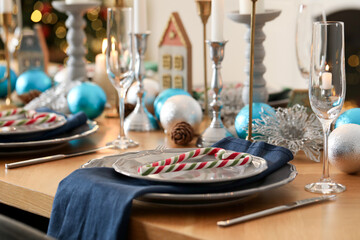 Festive table setting with Christmas decor at home, closeup