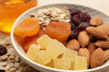 Making granola. Oat flakes, dried fruits and other ingredients on table, closeup