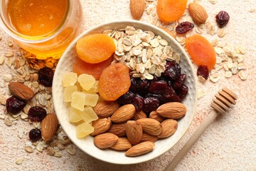 Making granola. Oat flakes, dried fruits and other ingredients on light table, flat lay